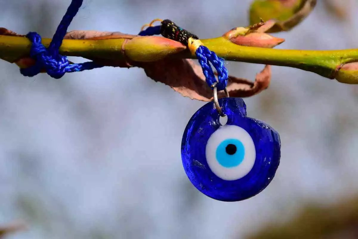 Collar con el ojo de la suerte en un árbol